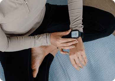 Participant activating the Hyfe CoughMonitor wearable before monitoring session